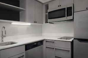 2 Bedroom Suite, 1 King 2 Doubles | Private kitchen | Fridge, microwave, stovetop, dishwasher