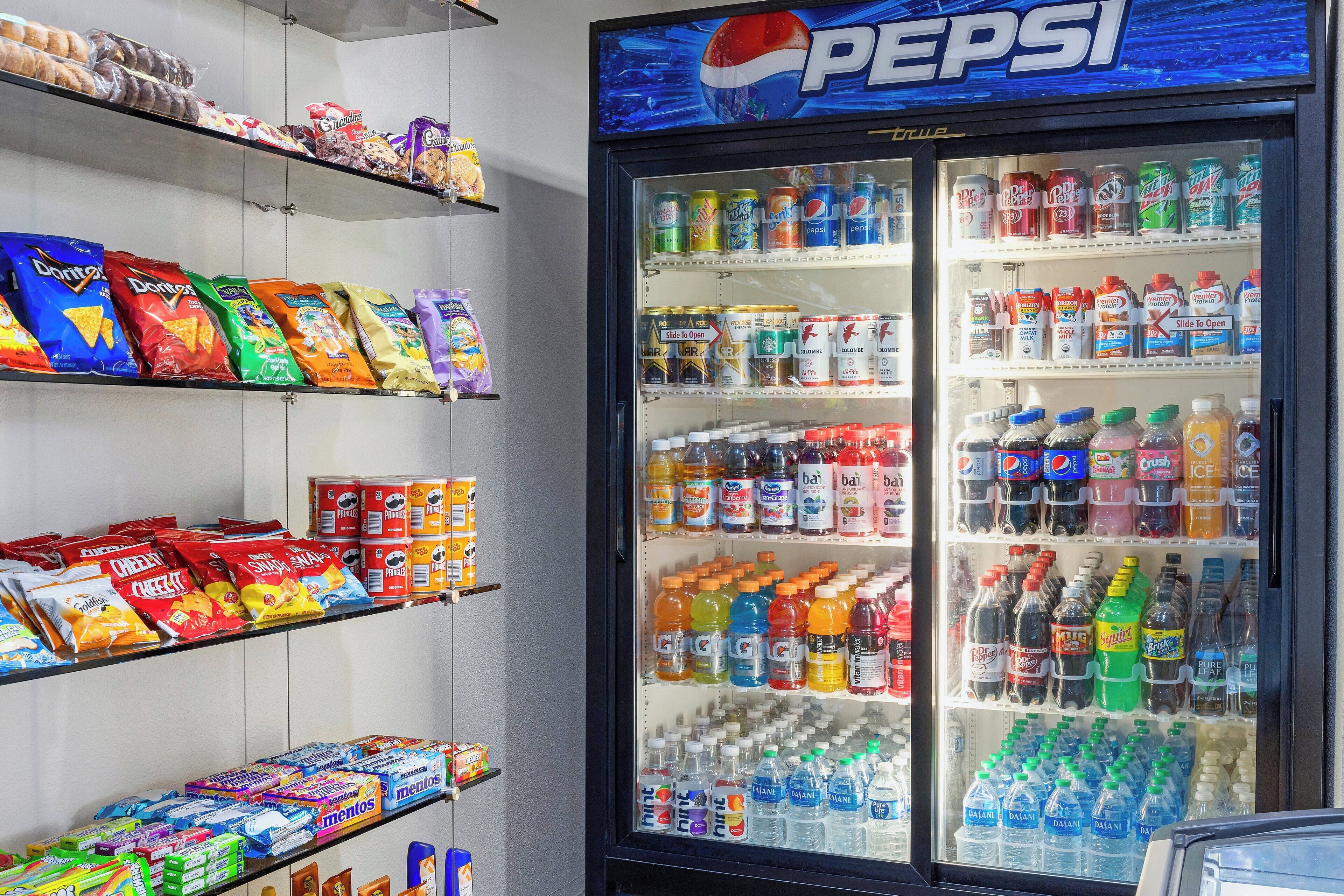 A vending machine stocked with various snacks and drinks, including chips, sodas, and bottled water.