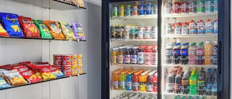 A vending machine stocked with various snacks and drinks, including chips, sodas, and bottled water.