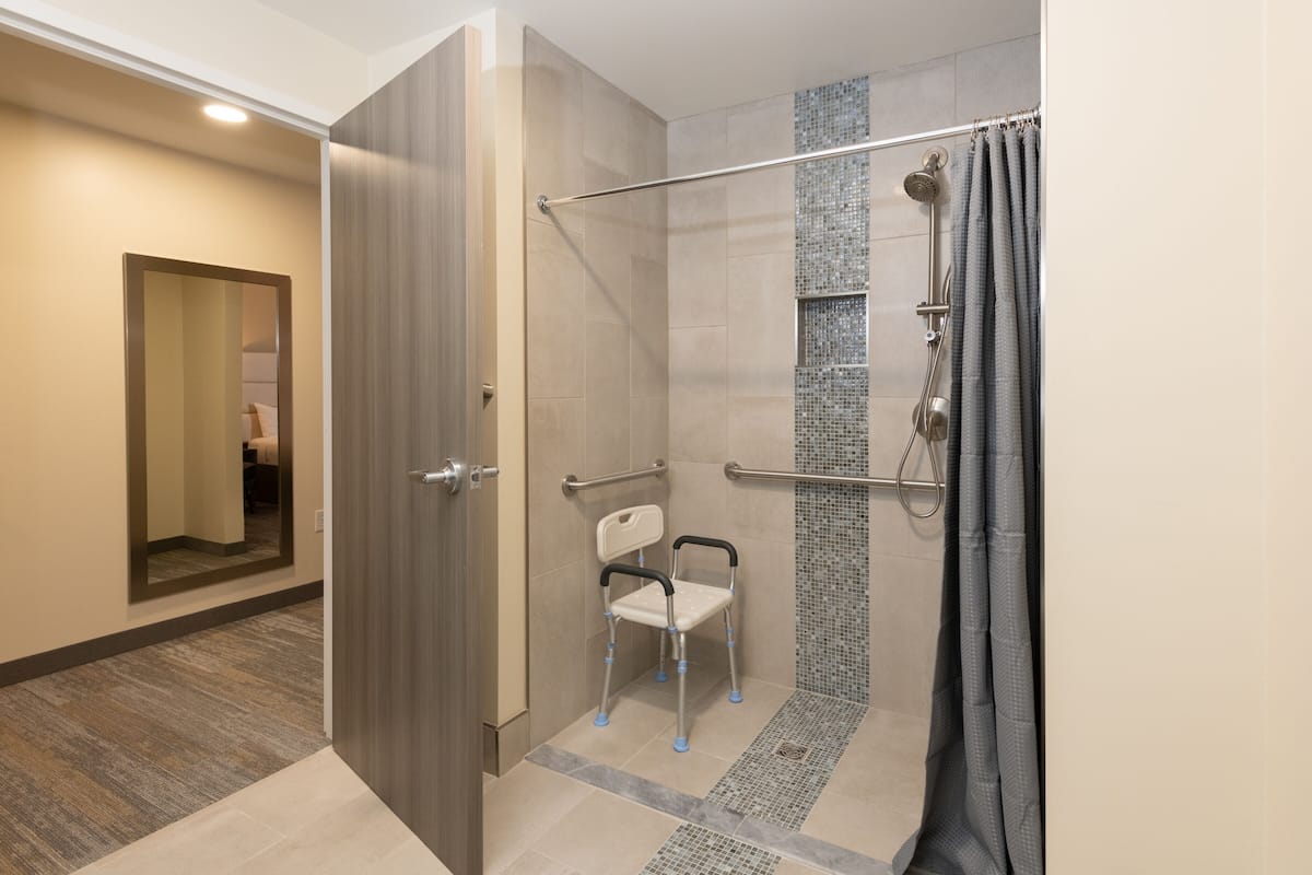 economy room, 1 king bed, accessible | bathroom | free toiletries, hair dryer, towels