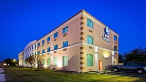 A multi-story hotel with a modern design, featuring a prominent Best Western sign. - Best Western Airport Inn & Suites Cleveland (Brook Park)