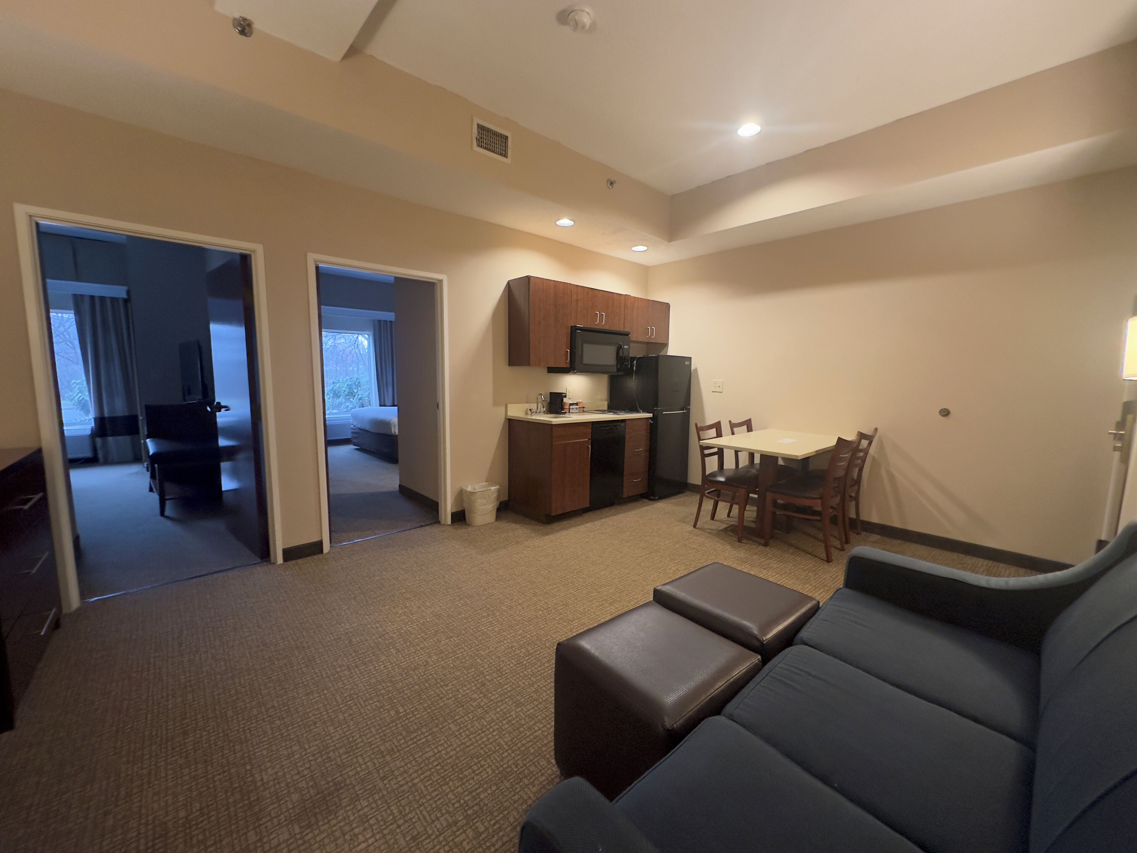 A compact living space with a kitchenette, a dining area, and a seating area.