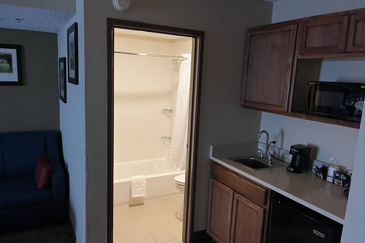 deluxe studio suite, 1 king bed, non smoking | bathroom | designer toiletries, hair dryer, towels, soap