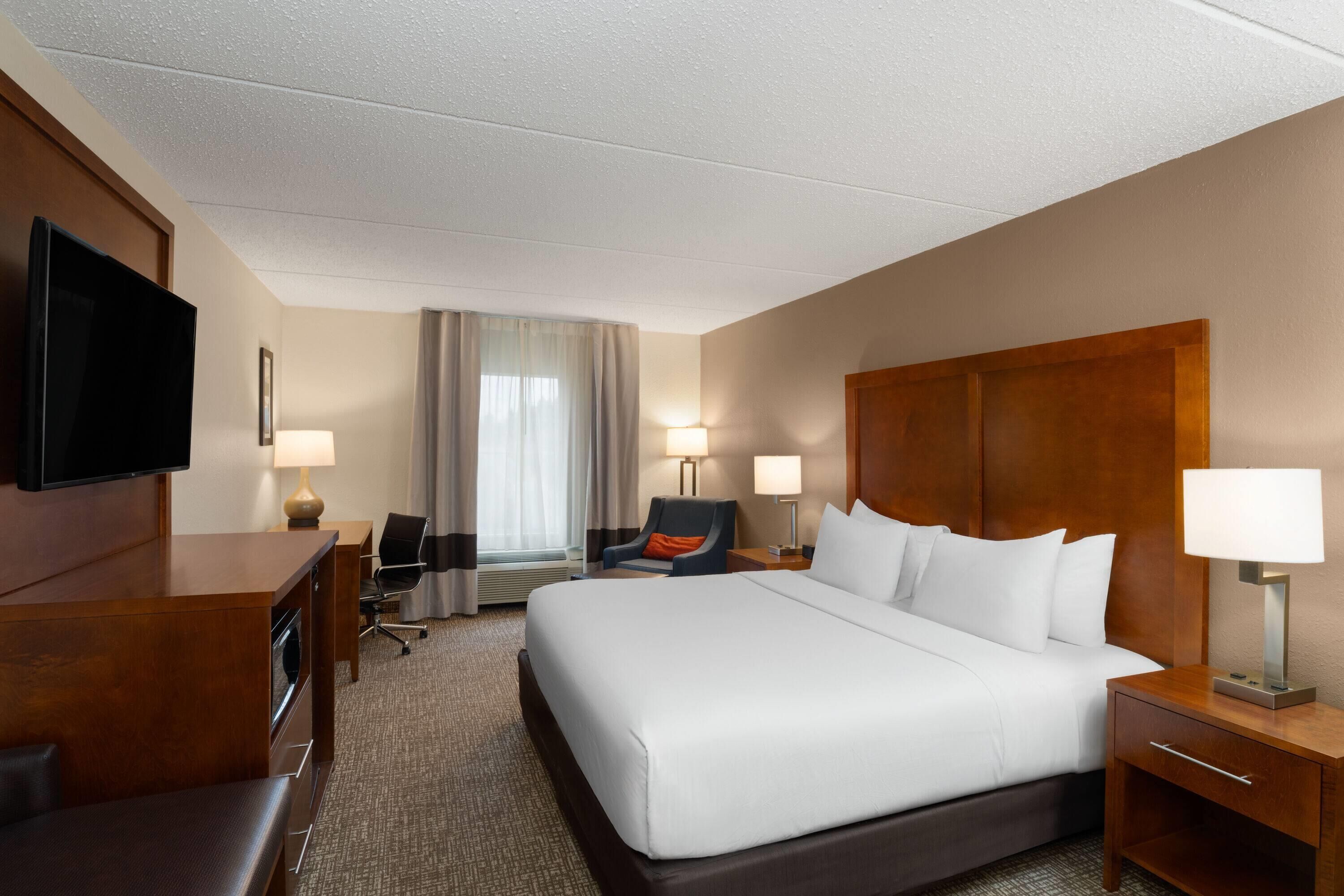 Desk, laptop workspace, blackout drapes, iron/ironing board