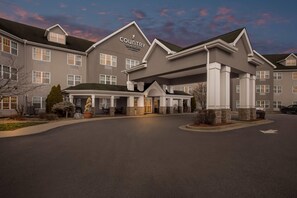 A large hotel with a prominent entrance and a covered walkway.