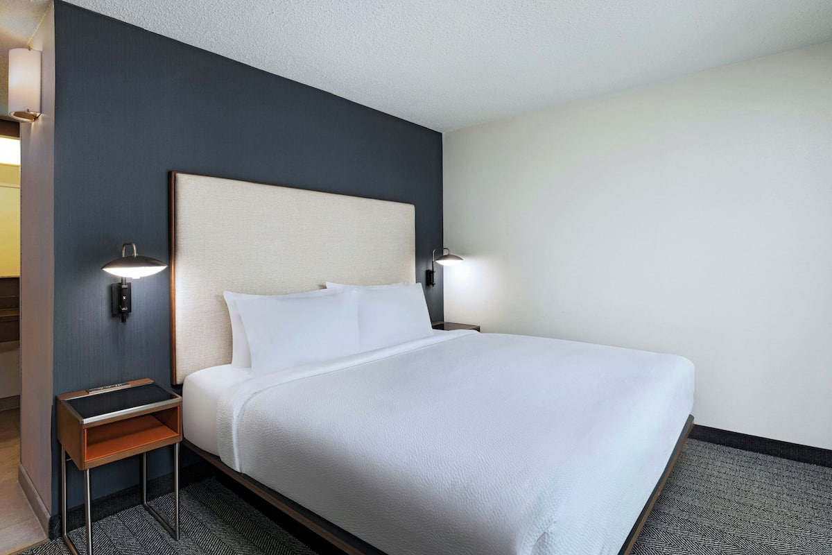 Premium bedding, desk, laptop workspace, blackout drapes