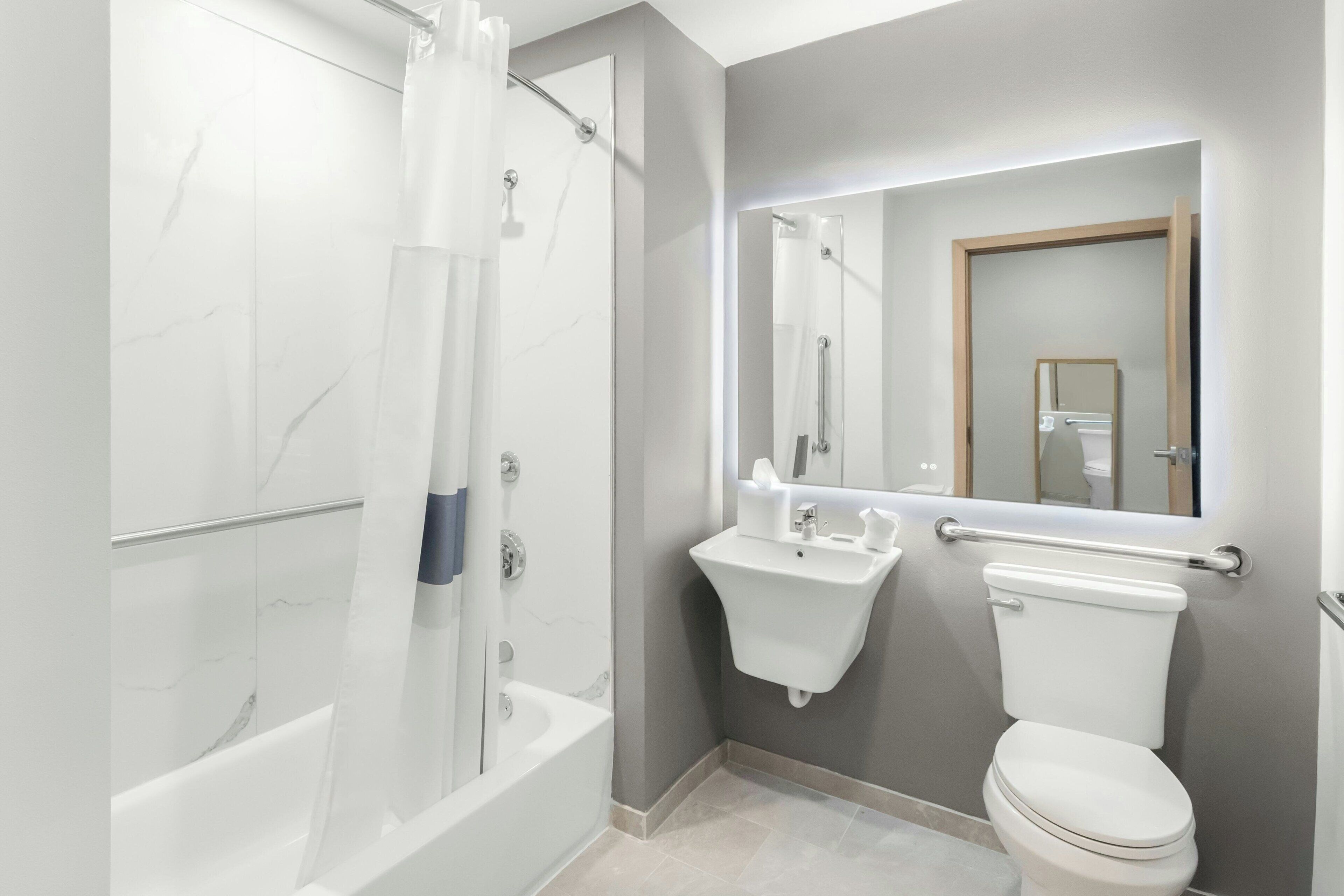 A bathroom with a bathtub, a sink, and a toilet.