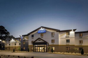 A multi-story hotel with a prominent City Express sign, a gated entrance, and a landscaped front yard. - City Express By Marriott Newport News (Newport News)