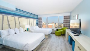 A hotel room with two beds, a desk with a TV, and a view of the city through large windows.