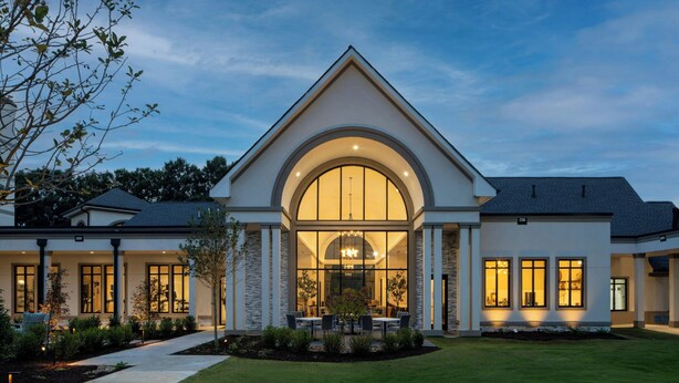 A modern house with a large arched window, a well-maintained lawn, and a patio area. - Residence Inn by Marriott Atlanta Buckhead (Atlanta)
