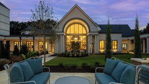 A modern house with a large arched entrance, outdoor seating, and a well-maintained lawn. - Residence Inn by Marriott Atlanta Buckhead (Atlanta)