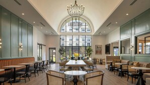 A spacious indoor area with high ceilings, a large chandelier, and multiple seating arrangements including tables and sofas. - Residence Inn by Marriott Atlanta Buckhead (Atlanta)