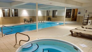 A swimming pool with a hot tub, tiled floor, and a few lounge chairs. - Sleep Inn Springfield South I60 near Medical District (Springfield)