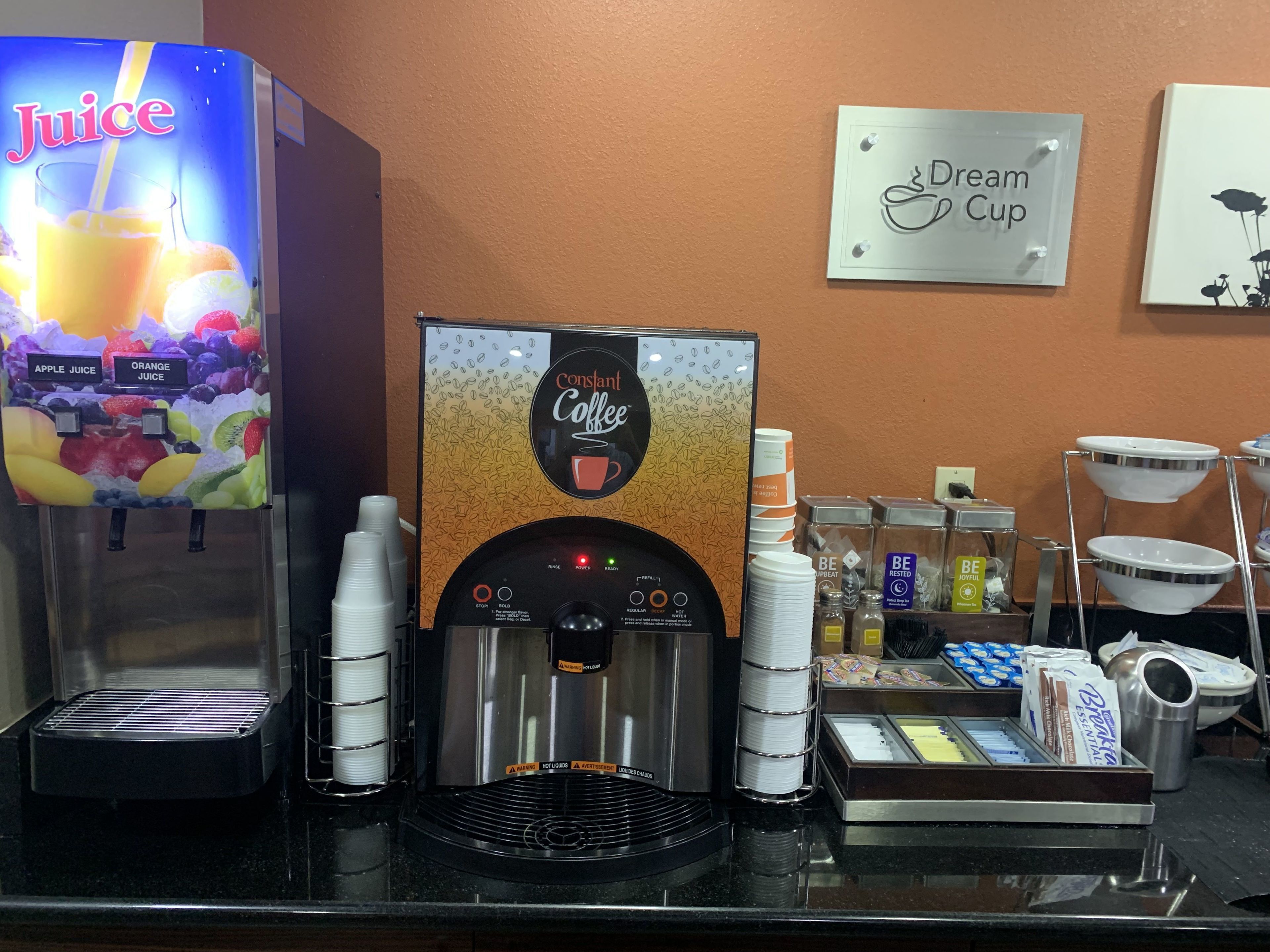 A coffee machine with a drip coffee option, a juice dispenser, and a coffee bean display.