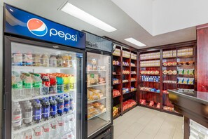 A convenience store with a Pepsi refrigerator, shelves stocked with snacks, and a Migali sign. - Quality Inn & Suites Denver International Airport (Aurora)