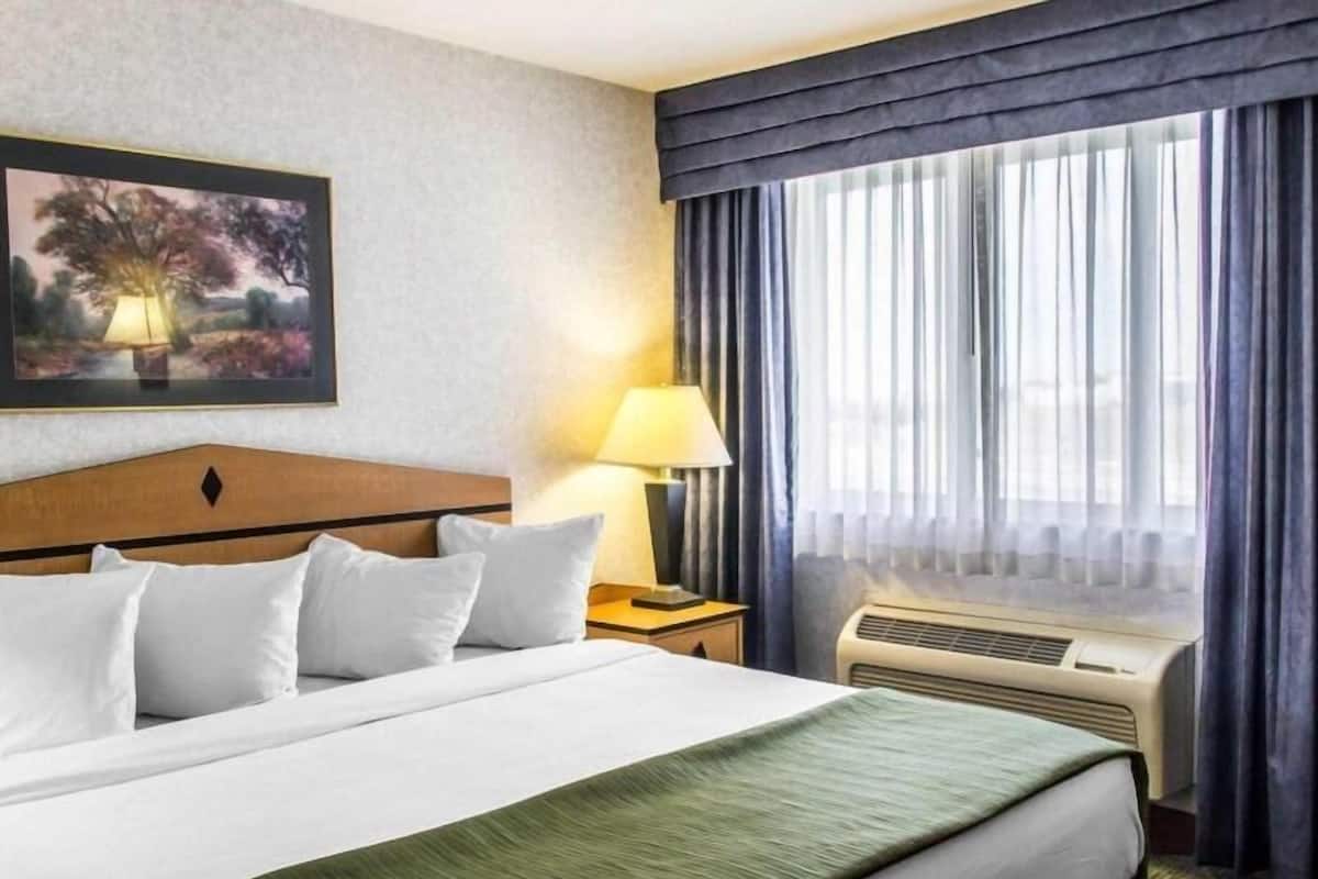 Desk, laptop workspace, blackout drapes, iron/ironing board