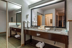 A hotel bathroom with a double sink, a large mirror, and a hairdryer. - Quality Inn & Suites Denver Airport - Gateway Park (Aurora)