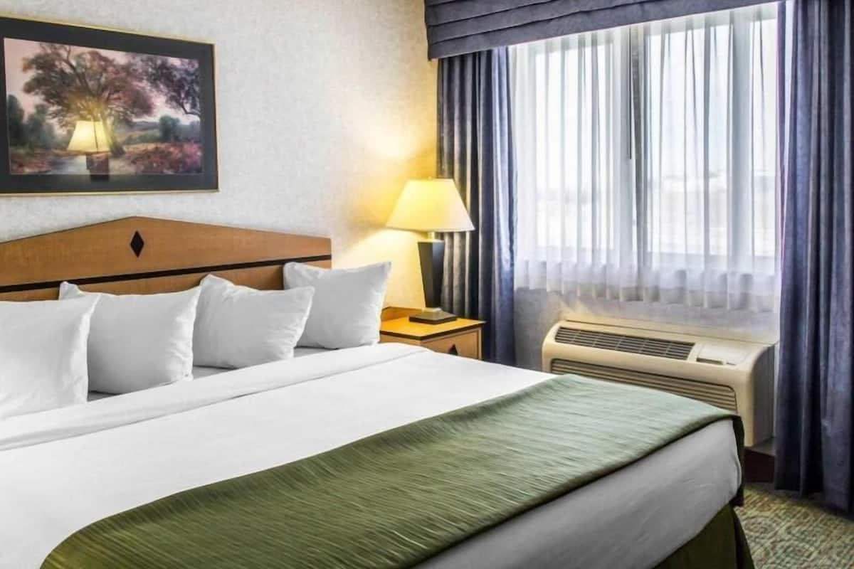 Desk, laptop workspace, blackout drapes, iron/ironing board