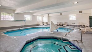 An indoor swimming pool with clear water, multiple lanes, and a changing room area. - Quality Inn & Suites Gallup I-40 Exit 20 (Gallup)