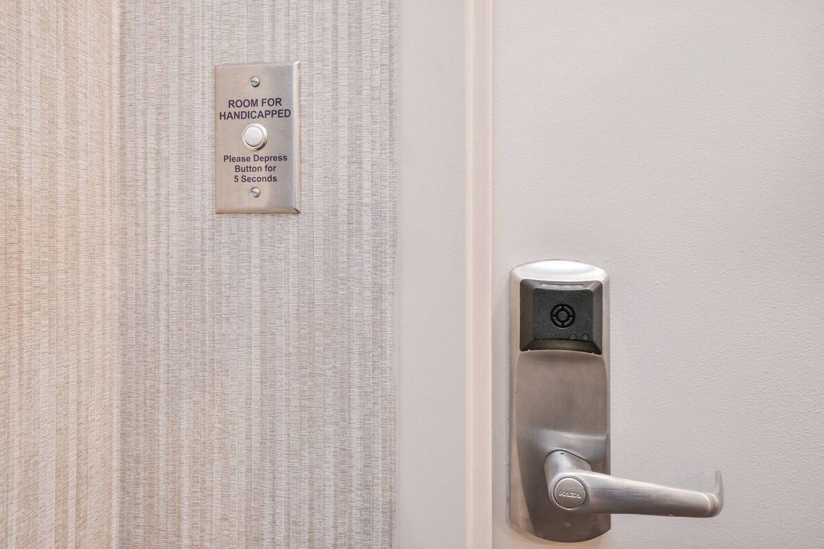A door with a tactile surface and a push button for the handicapped.