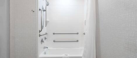 A bathroom with a shower, a bathtub, and a toilet.