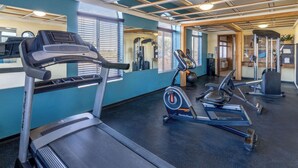 A gym with treadmills, an elliptical, and a weight machine.