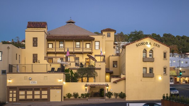 A two-story building with balconies and a sign reading "Sonora Inn".