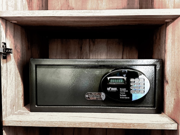 A black safe with a digital keypad, labeled "SAFEMARK SYSTEMS," inside a wooden cabinet. - Historic Sonora Inn (Sonora)