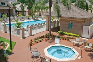 A pool area with a hot tub, lounge chairs, and a spa rules sign. - Homewood Suites by Hilton - Fort Myers (Fort Myers)