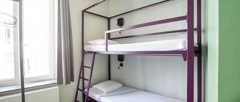 A bunk bed room with a ladder, a window with curtains, and a black and white patterned floor.