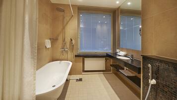 A modern bathroom with a freestanding bathtub, a vanity with a sink, and a shower area.
