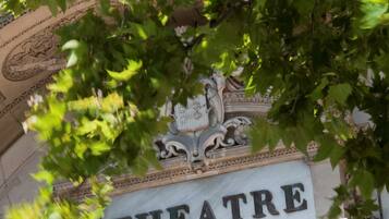 A building facade with the word "THEATRE" prominently displayed.