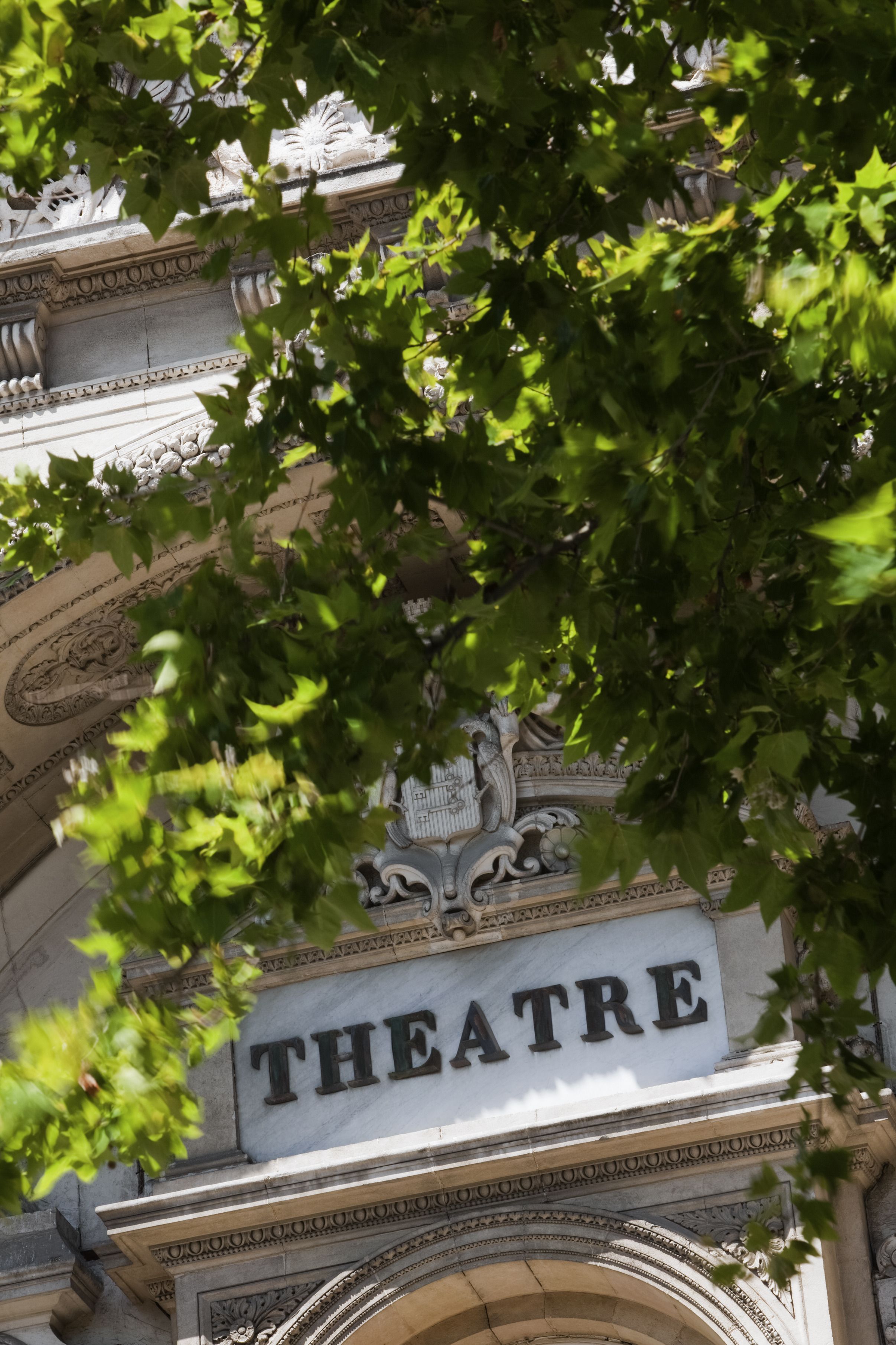 A building facade with a sign that reads "THEATRE."