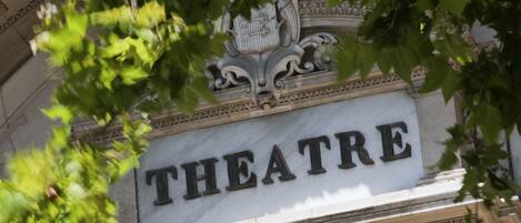 A building facade with a sign that reads "THEATRE."