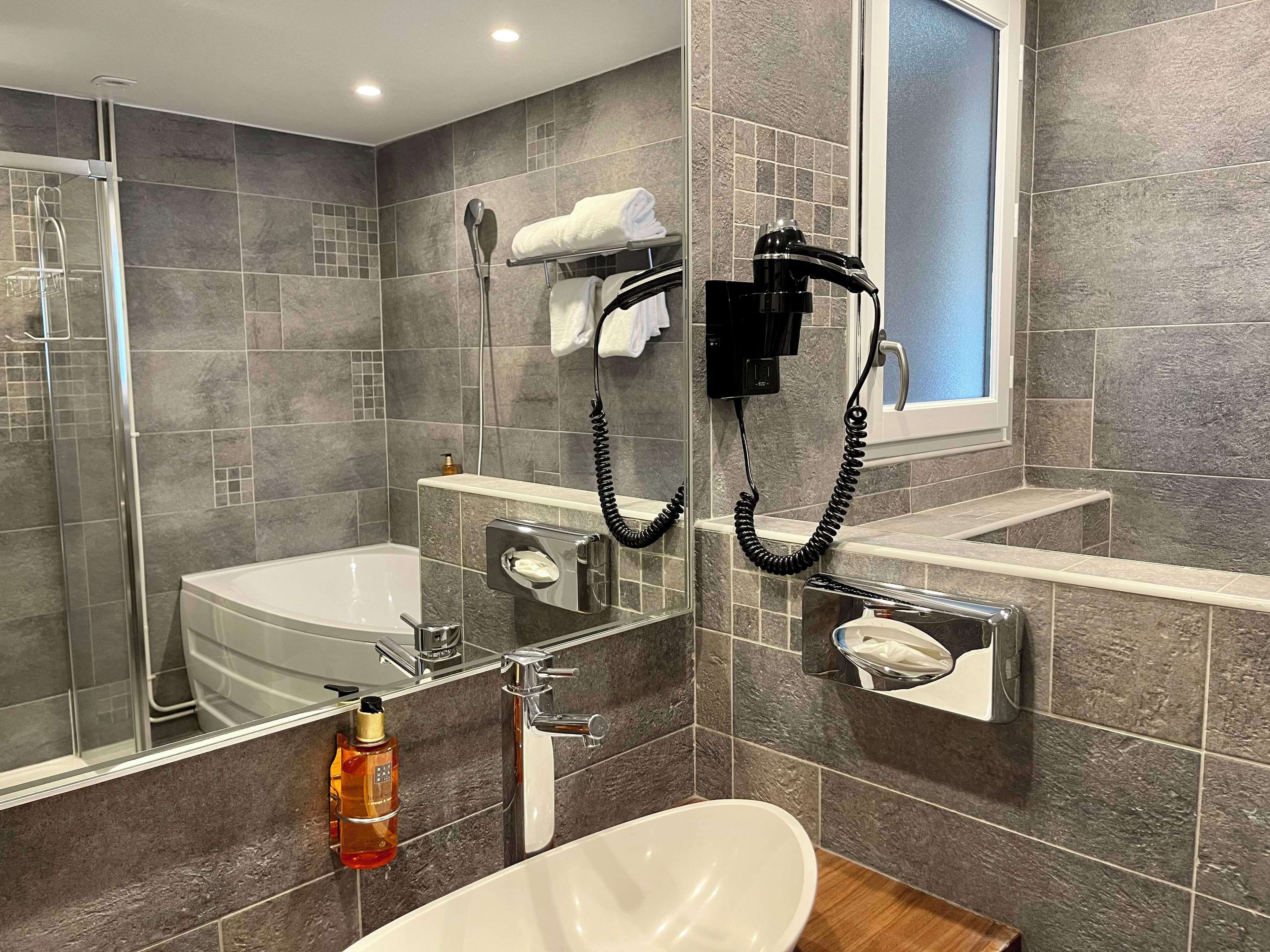 deluxe room, multiple beds, non smoking | bathroom | free toiletries, hair dryer, towels, soap