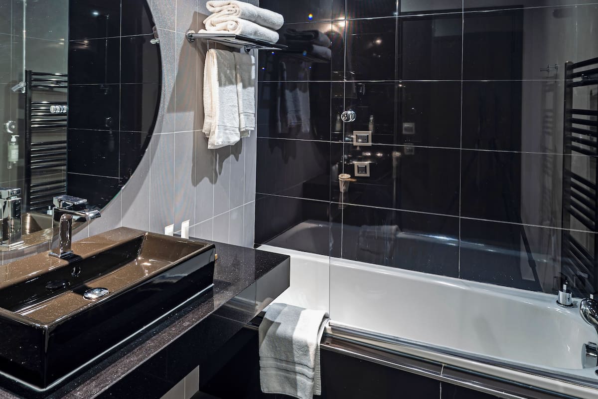 designer toiletries, hair dryer, bathrobes, slippers