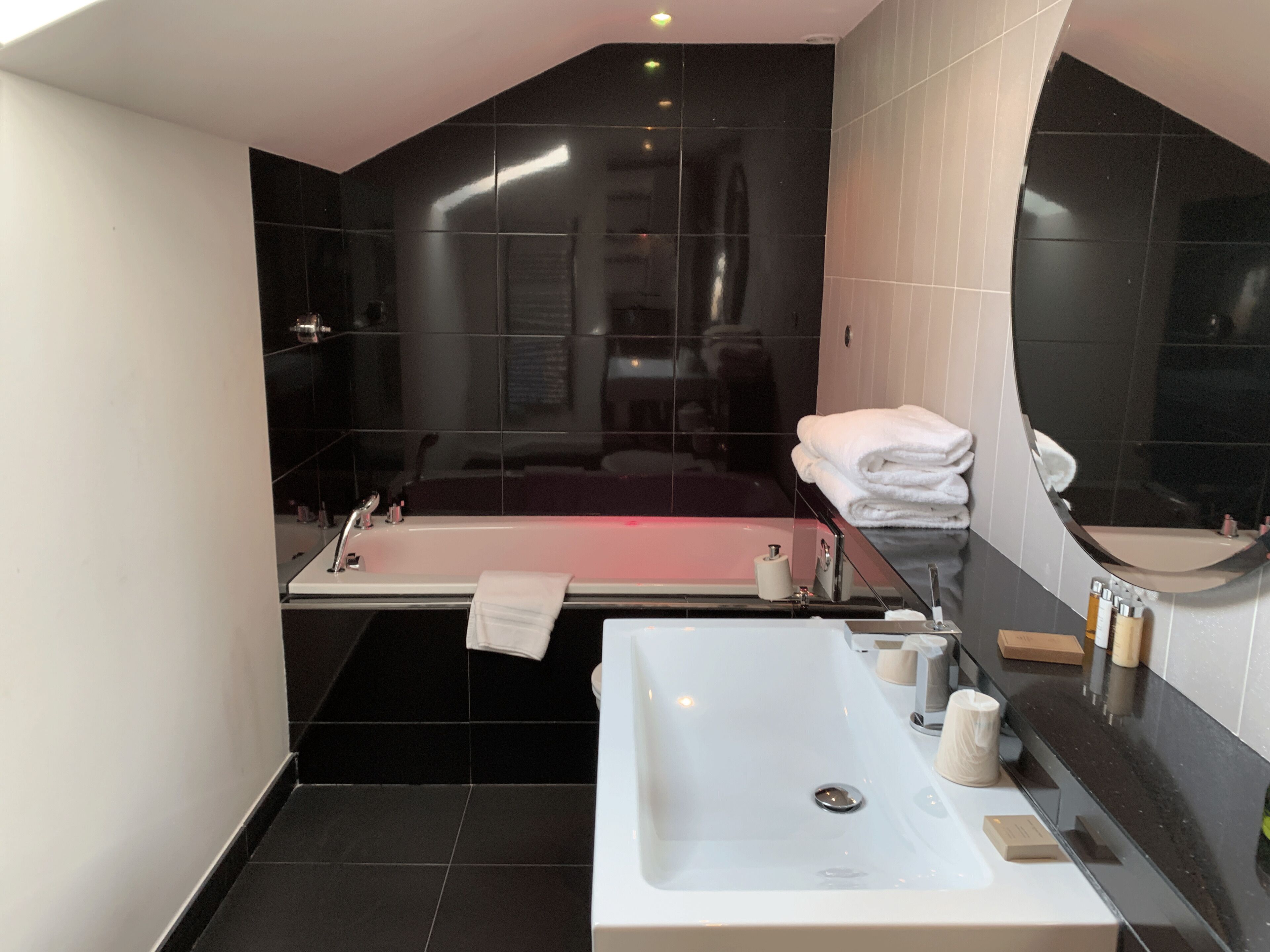 A modern bathroom with a bathtub, a separate shower area, and a vanity with a sink.
