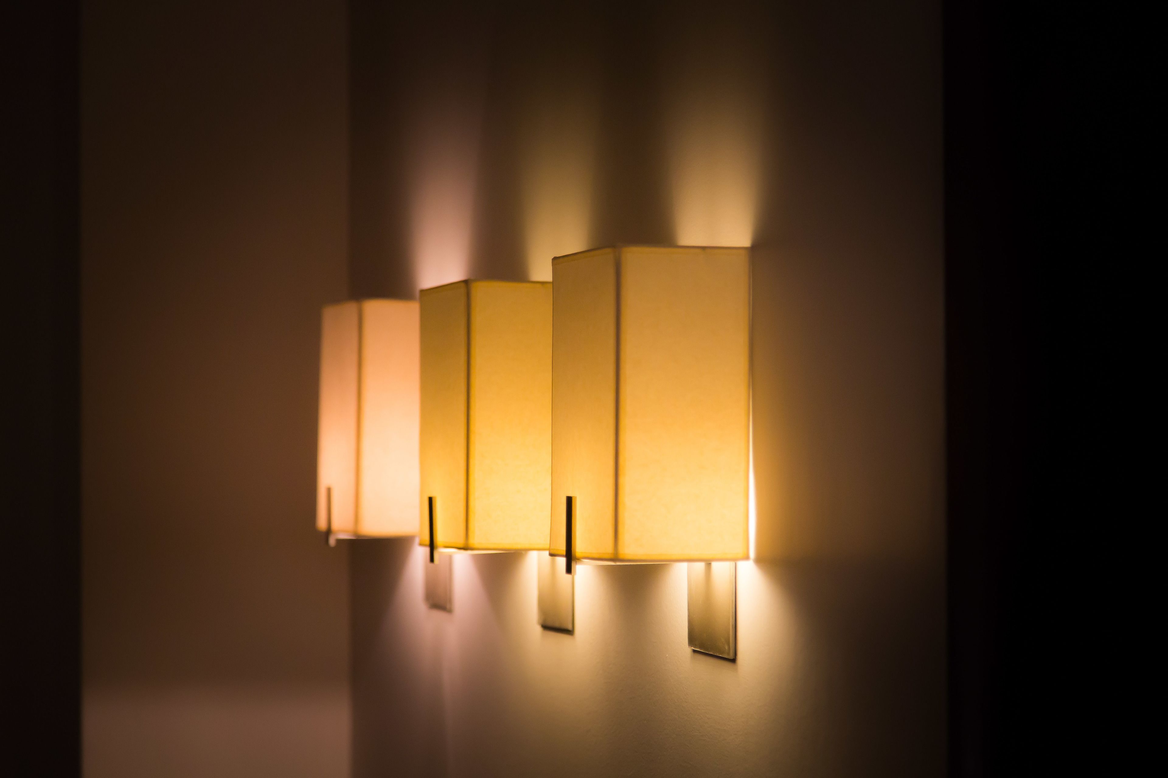 A wall-mounted light fixture with four rectangular panels.