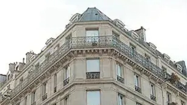 A multi-story building with a classical architectural style, featuring ornate balconies and a symmetrical facade. - Hotel Quartier Latin (Paris)