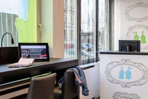 Work and unwind in a functional space with a desk, chair, and large windows offering a view.