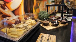 A buffet with various cheeses, fruits, and meats. - Hotel Am Triller (Saarbrücken)