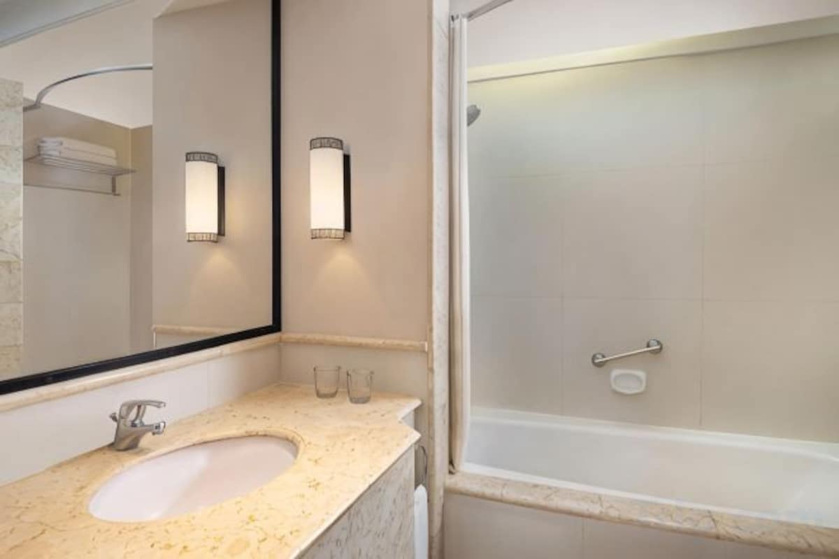 Bathroom | Rainfall showerhead, hair dryer, bathrobes, slippers