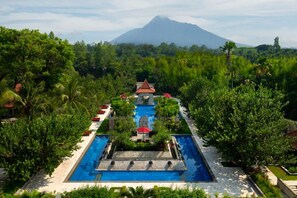 Relax by the serene pool surrounded by lush greenery and take in the breathtaking mountain views.