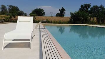 Seasonal outdoor pool, open 7:00 AM to 8:00 PM, pool loungers