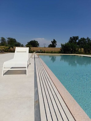 Seasonal outdoor pool, open 7:00 AM to 8:00 PM, pool loungers