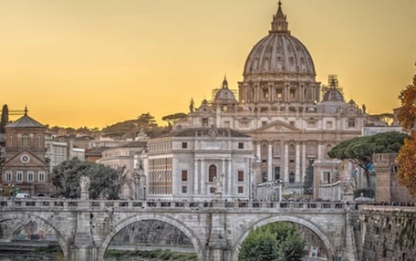 A historic bridge with arches leading to a large domed building, likely a significant landmark.