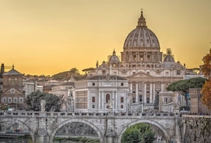A historic bridge with arches leading to a large domed building, likely a significant landmark. - Hotel Dei Mellini (Rome)