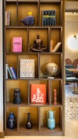 A bookshelf with various books, a globe, and decorative items.
