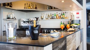 A modern bar area with a variety of liquor bottles, a coffee machine, and a menu board. - Best Western Plus Hotel Farnese (Parma)
