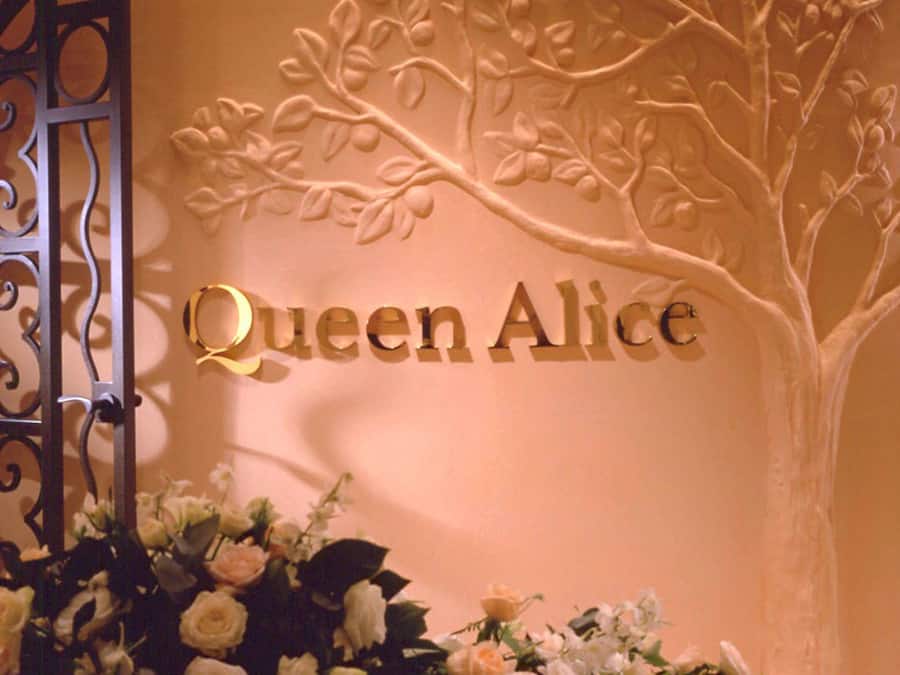 A wall with the name "Queen Alice" and a tree design.